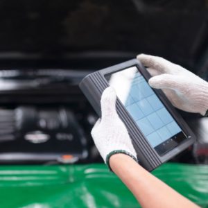 using a tablet for troubleshooting a car