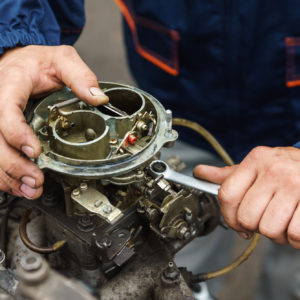 carburetor being repaired by mechanic