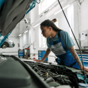 female mechanic looks for the fuel injector causing p0264 code