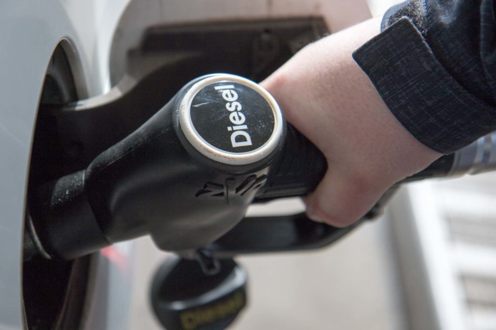 hand holding black gas pump nozzle