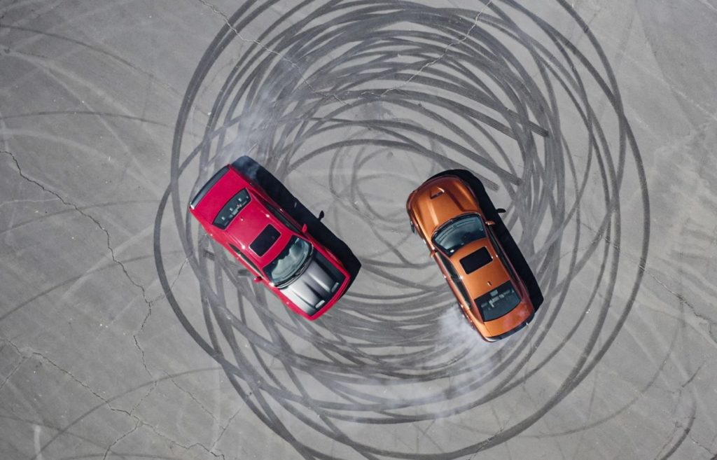 red and orange cars doing donut