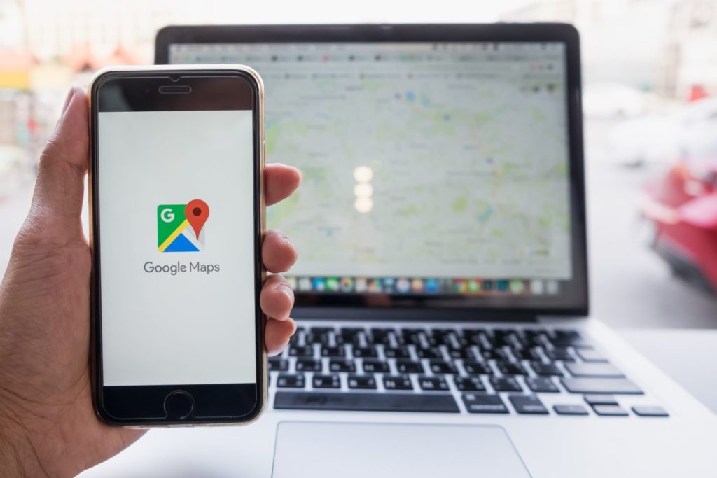 checking google maps on phone and laptop