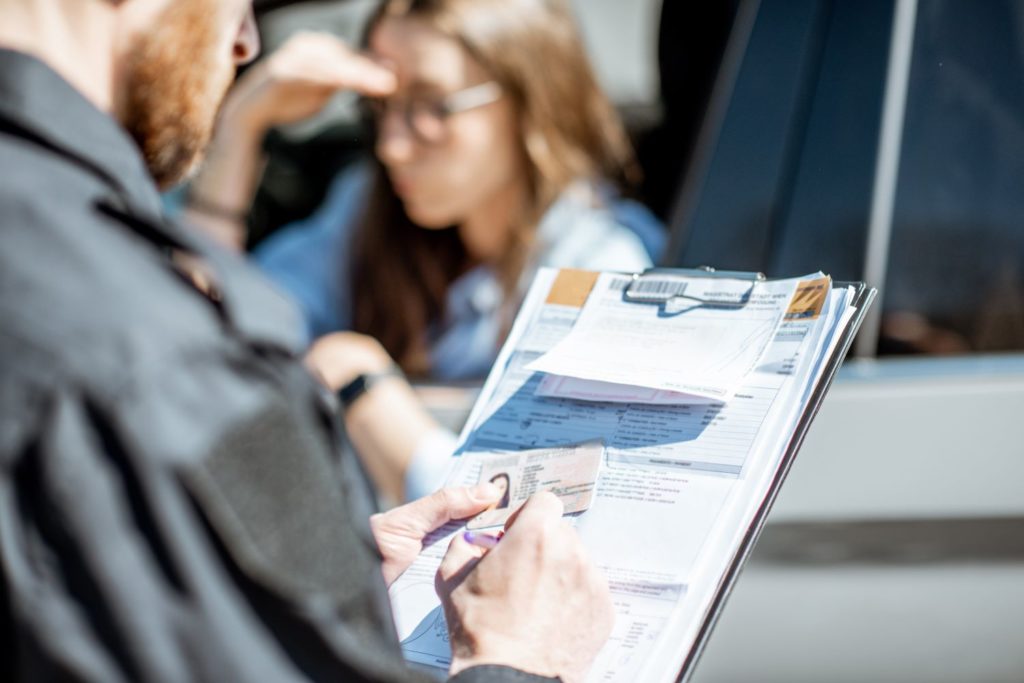 police officer issuing traffic violation to a female driver