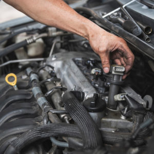 automotive mechanic testing and checking ignition coils