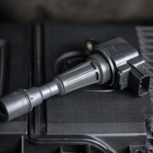 modern car ignition coil on top of an engine