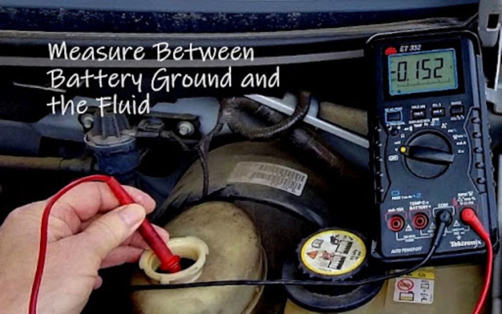 mechanic checking moisture in the brake fluid