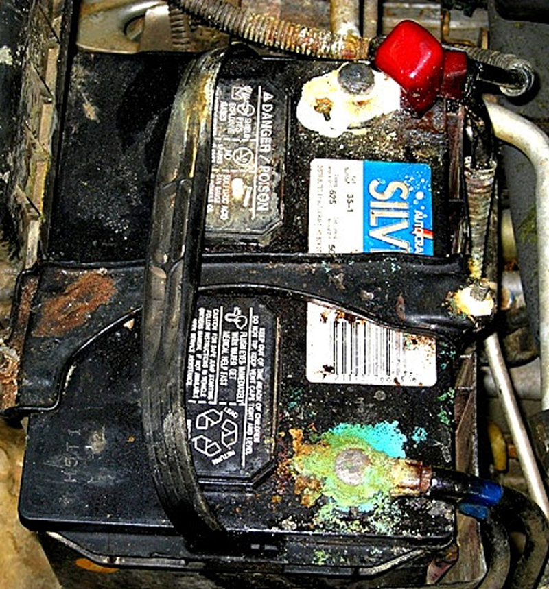car battery with cables needing replacement