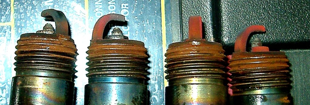 spark plugs developed red conductive dust