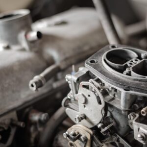 car carburetor with engine in background