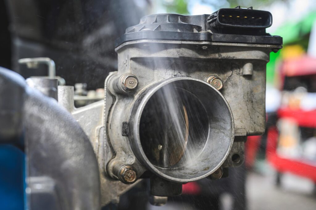 car throttle body being cleaned