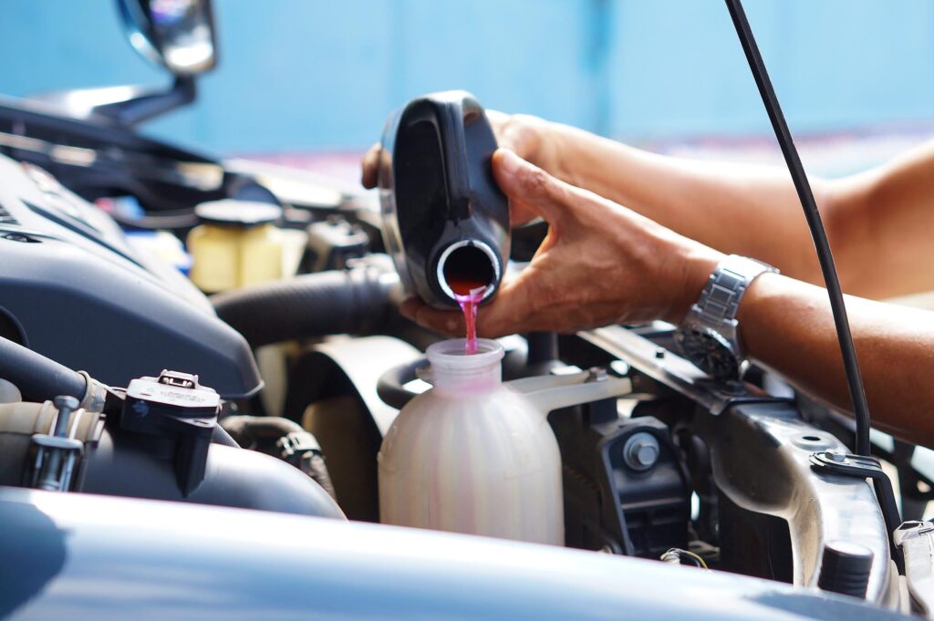 pouring coolant to address coolant leaks