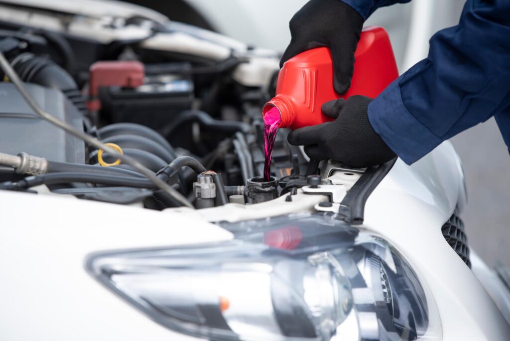 professional pouring car coolant into the radiatior