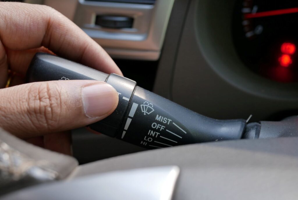 hand moving windshield wipers switch
