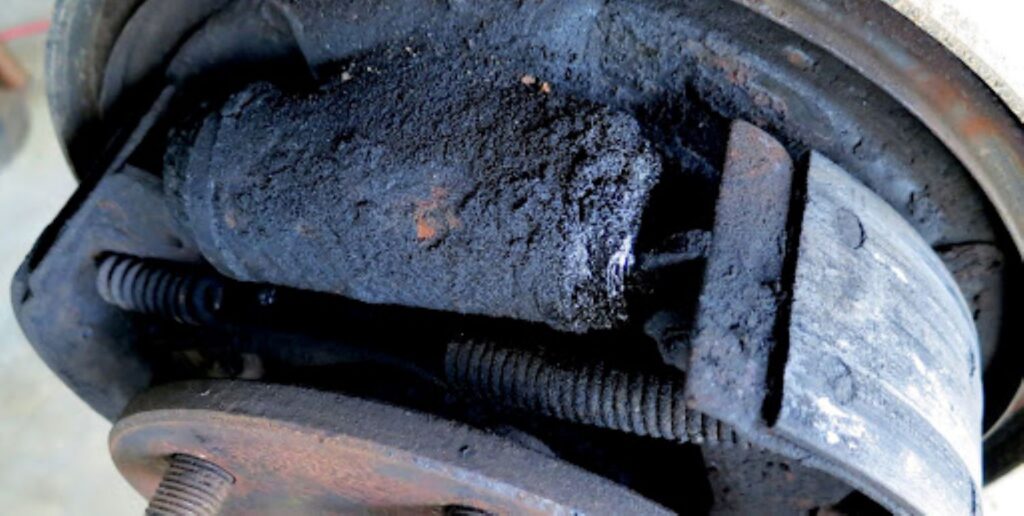 image showing a backing plate with brake fluid leak