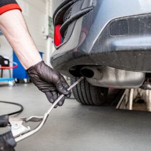 mechanic performing emissions test