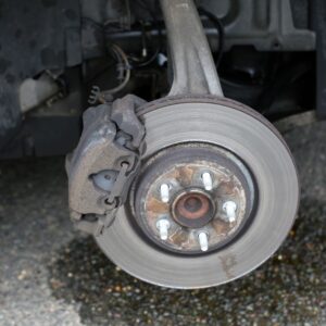 brake disc and caliper with a brake fluid leak underneath
