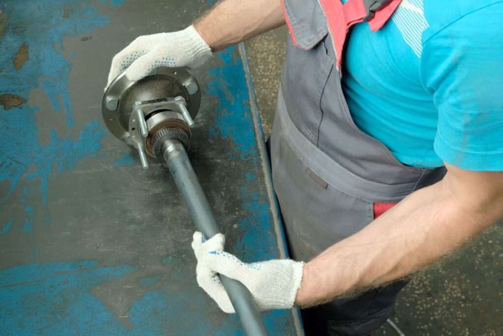 mechanic checking a car axle