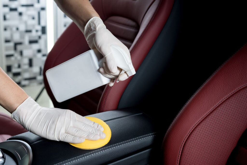 spraying leather conditioner to the car interior