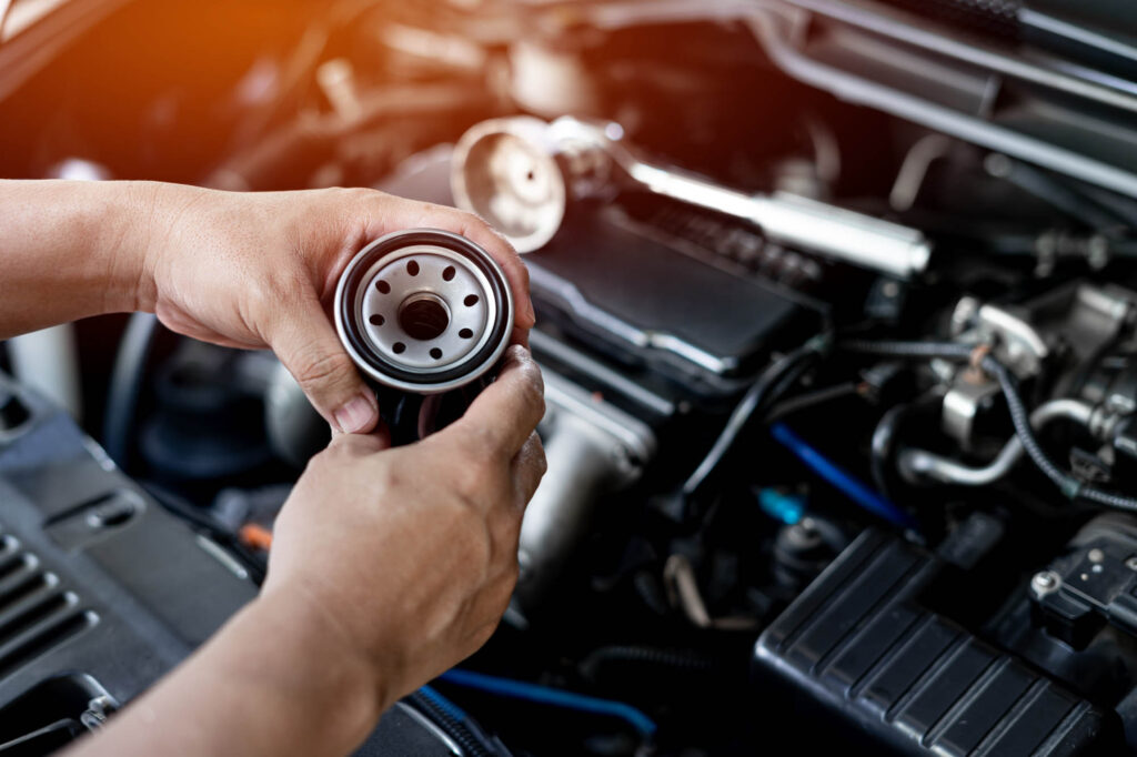 Close,Up,Oil,Filter,Of,Car,And,Wrench,On,Engine