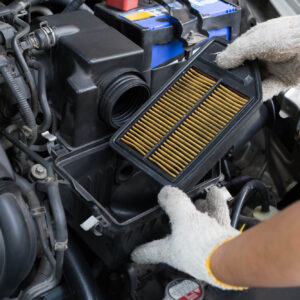 changing dirty air filter over a car engine