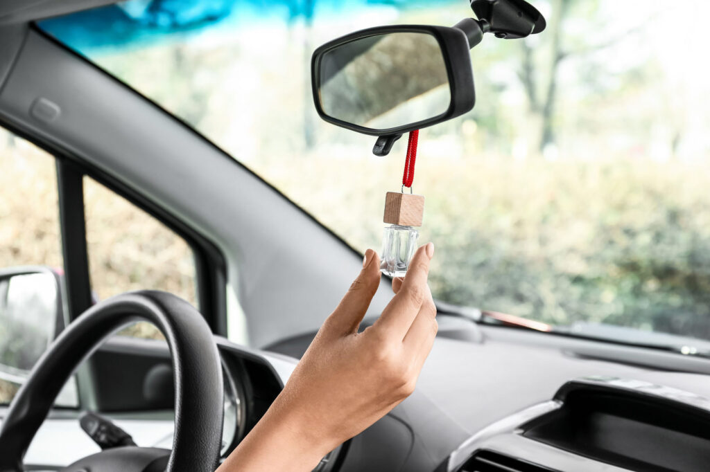 Female,Hand,With,Air,Freshener,Hanging,In,Car