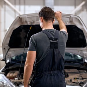 man checking for car issue