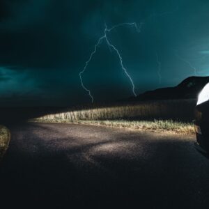 car driving in a thunderstorm with lightning