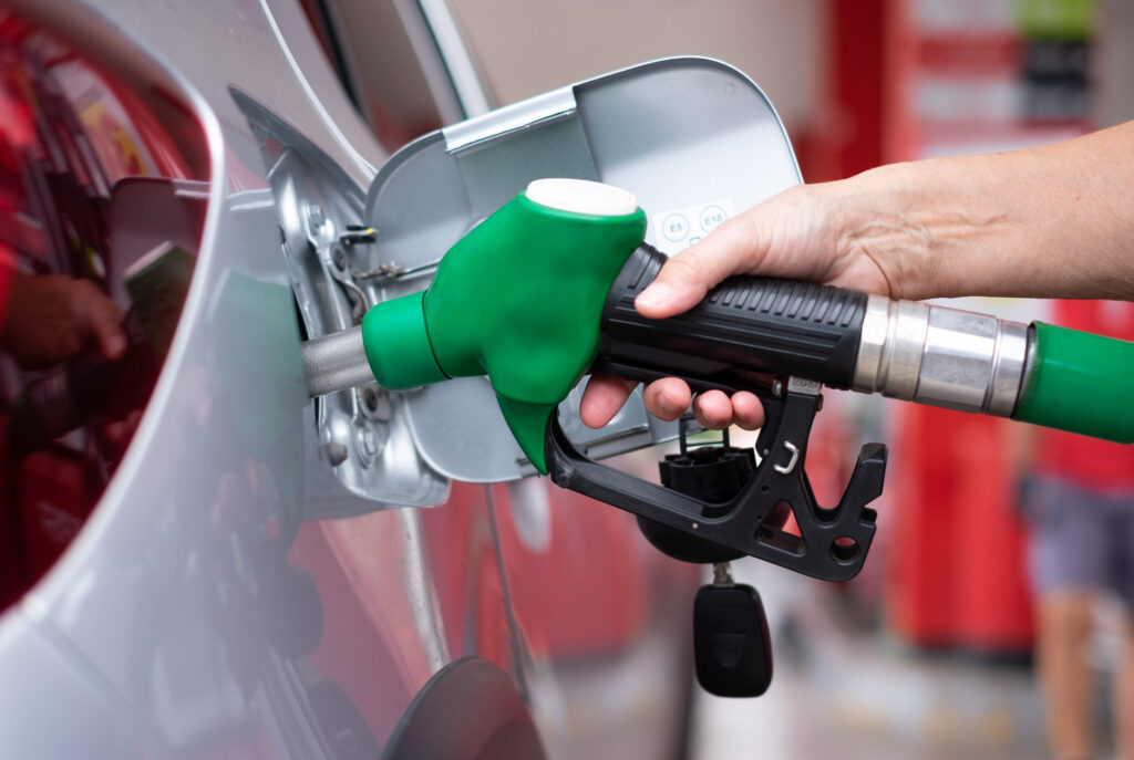 driver using gas station pump