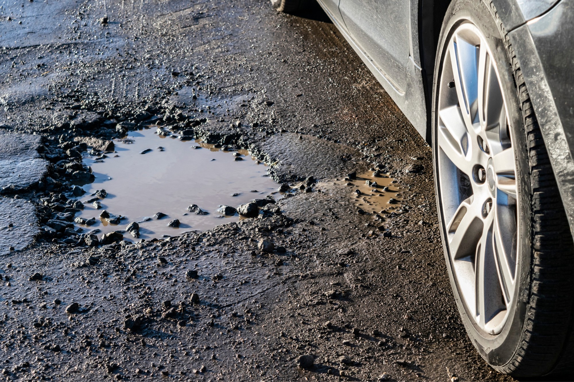 Dealing With Pothole Damage Insurance Coverage and Reimbursement Guide In The Garage with
