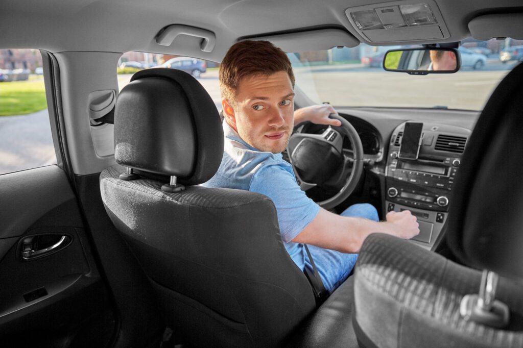 man looking back to do reverse parking