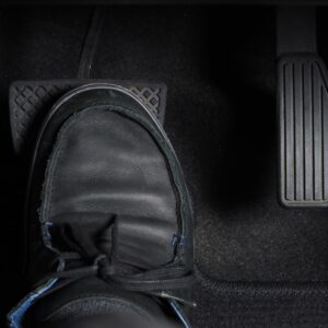 foot stepping on the brake pedal