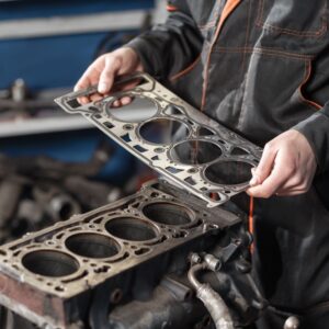 mechanic replacing an old head gasket