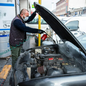 man cleans car automotive engine bay