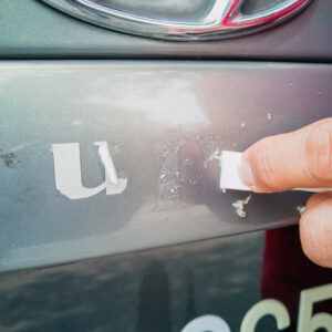 removing adhesive from car paint
