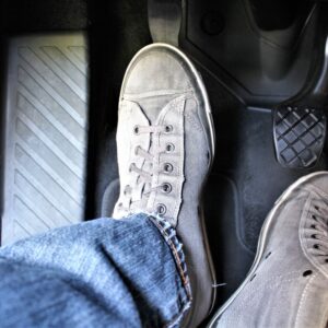 foot stepping on the clutch pedal