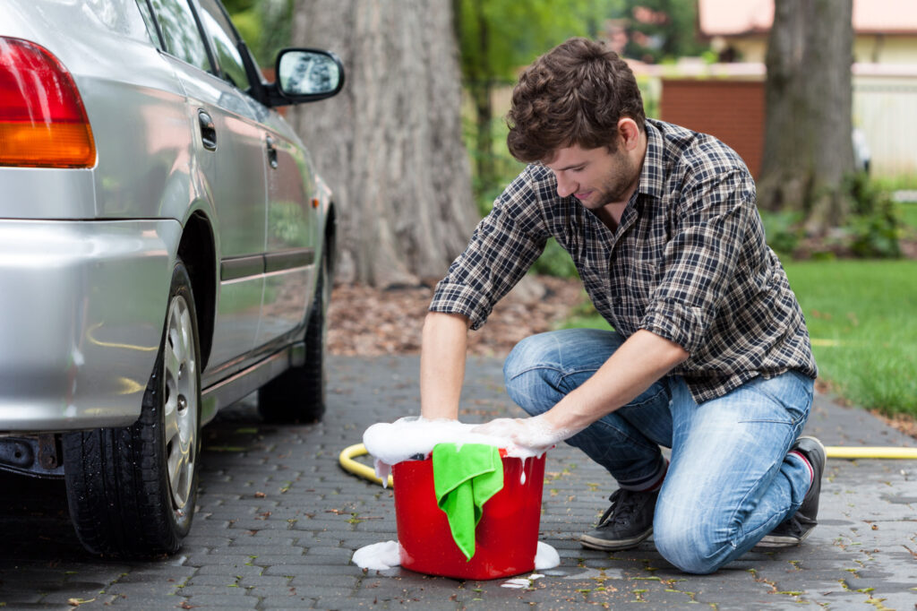 scrubbing car with soap and water