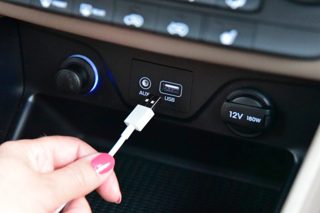 cable being plugged to car usb port