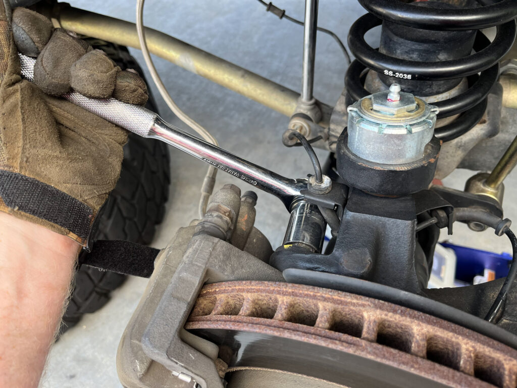 using a 15mm to remove the caliper bolts