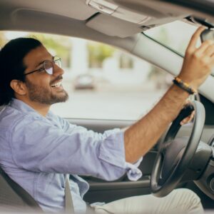defensive driver checking rear view mirror