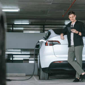 man charging ev at a public space