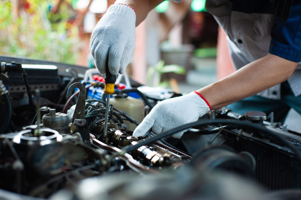 mechanic checking camshaft of car