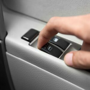 finger lifing a power window switch