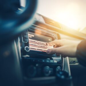 driver operating the car radio