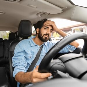 car driver stressed over stiff steering wheel