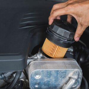 mechanic inserting new oil filter
