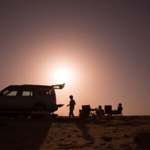 silhouette shot of desert camping