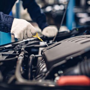 mechanic checking engine oil