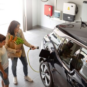 mother and son charging an ev at home