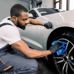 man cleaning tire car detailing