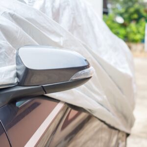 covered car with side mirror exposed